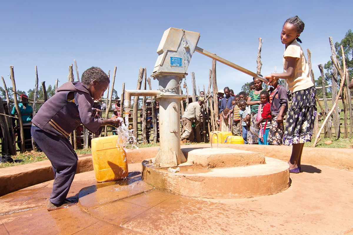 Kinder betätigen einen Brunnen in Äthiopien