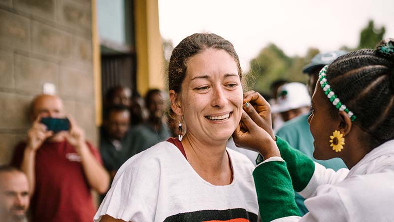 Julia Krasser erhält traditionellen Schmuck von Frau in Äthiopien