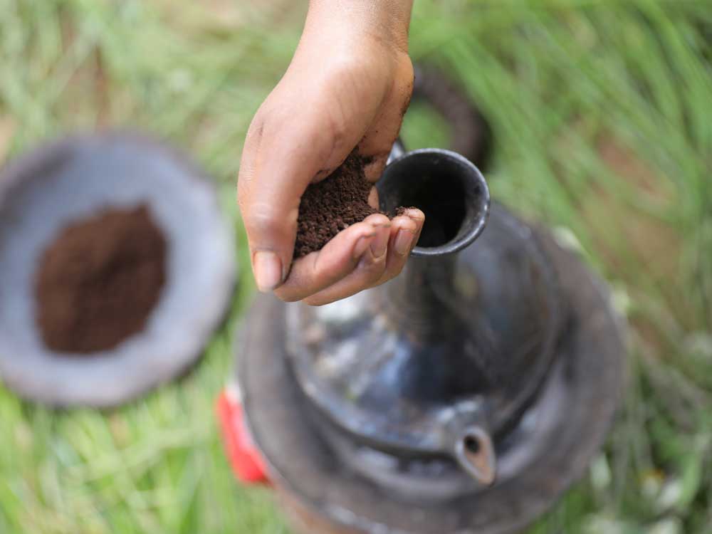 Gemahlener Kaffee in Äthiopien wird in ein Jabana gefüllt